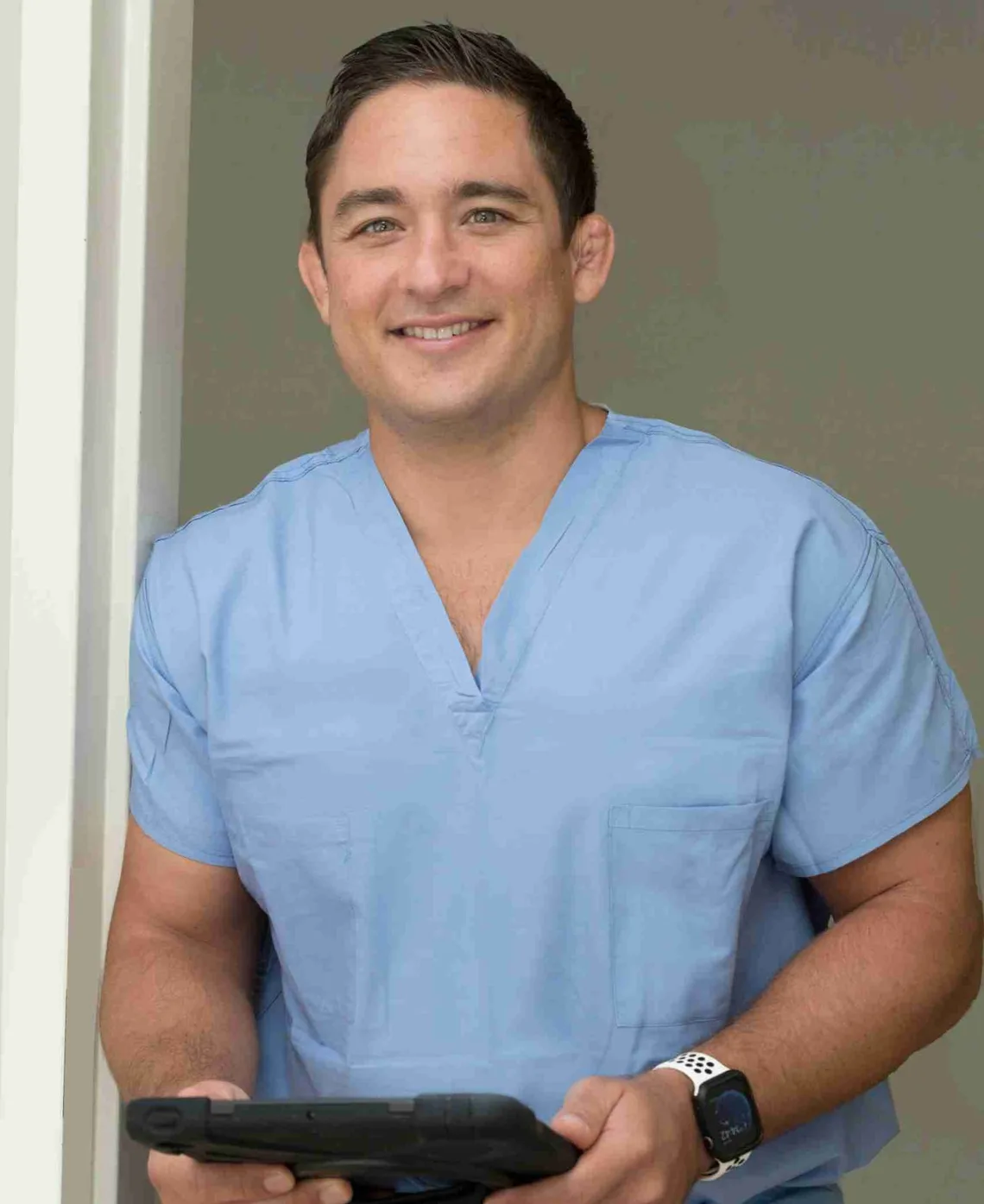 Paul N. Morton, MD, in surgical scrubs.