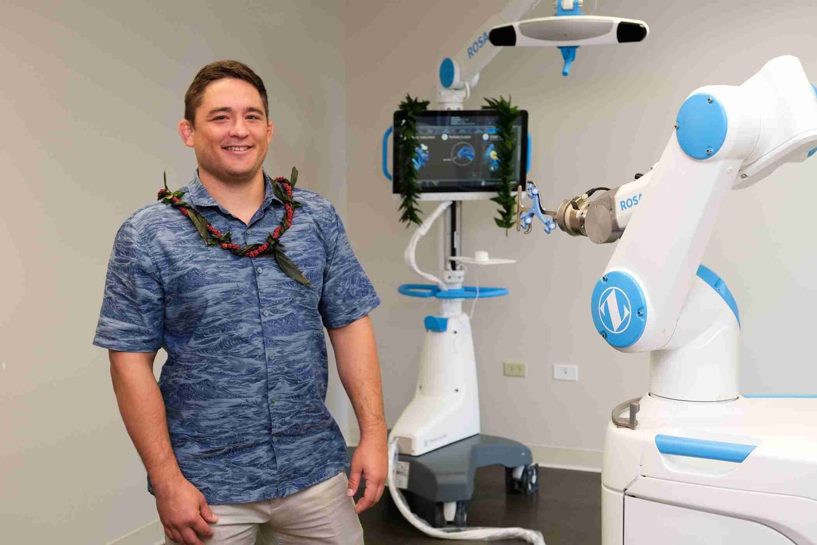 Dr. Paul Morton stands beside the ROSA Knee robotic surgical system.